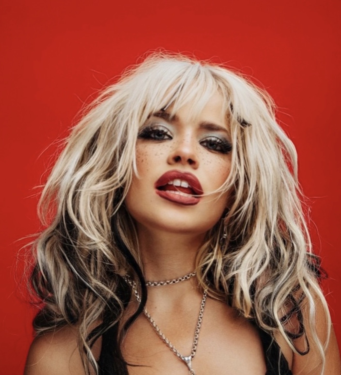 Portrait of Shelby Carter against a vivid red backdrop